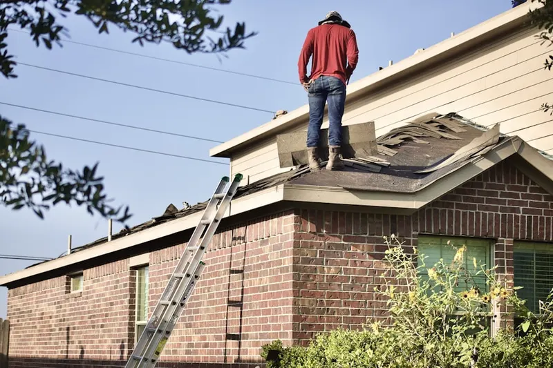 Professional roofer working on a residential roof in Whiteland